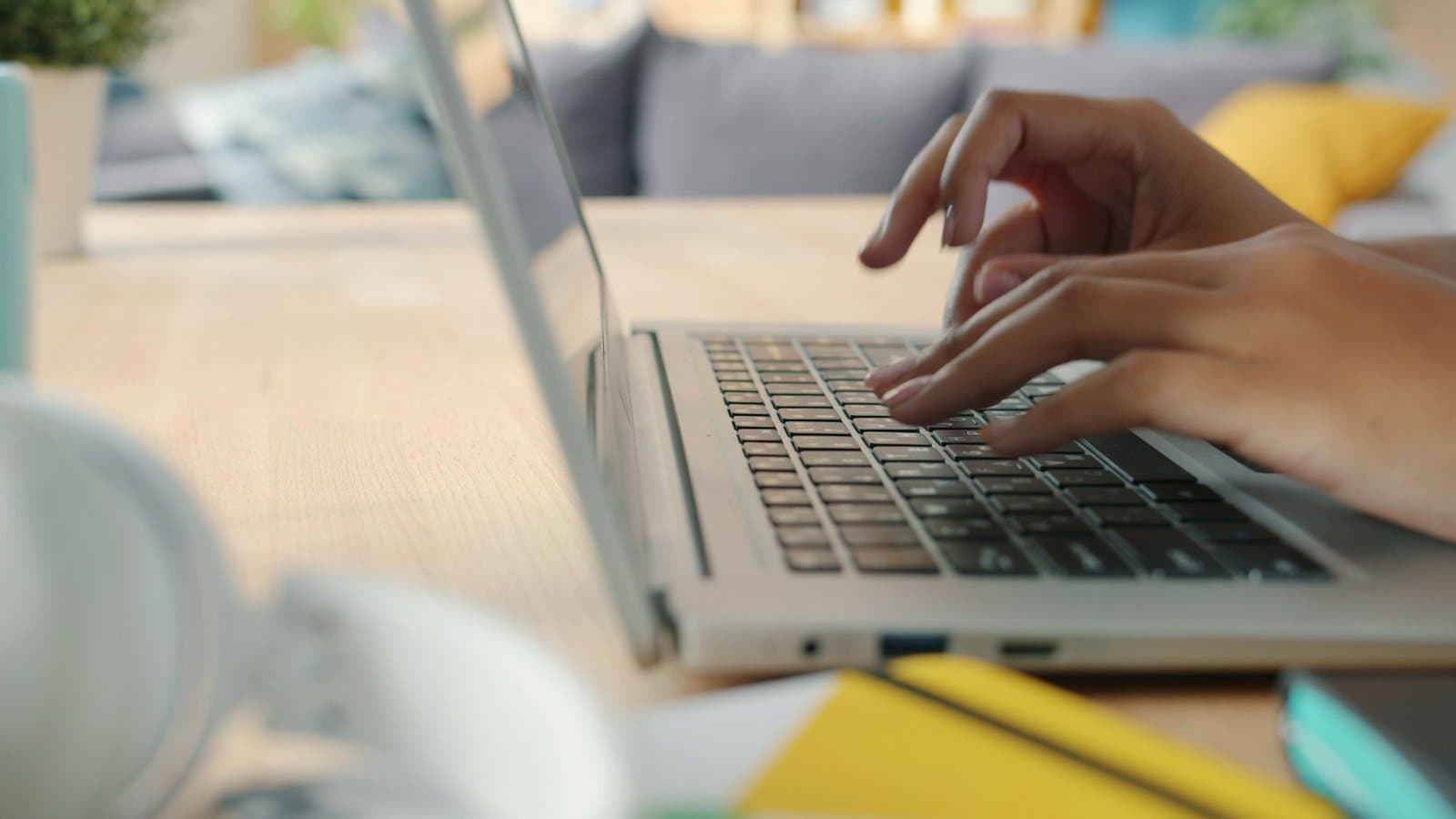 Hands typing on a laptop at a clean desk